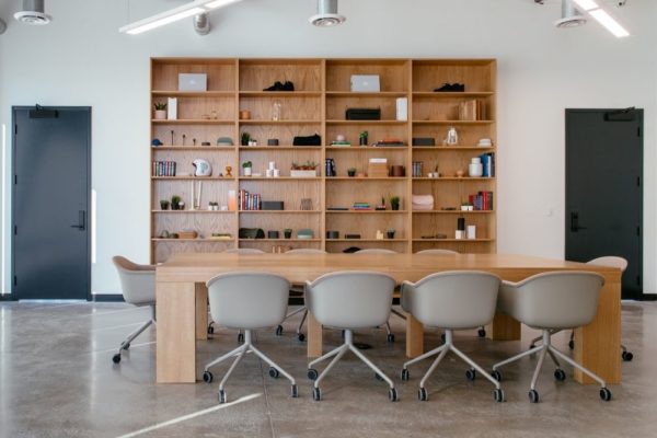 Large working table with bookshelves in office